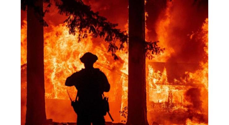 Firefighters battle California blaze generating its own weather
