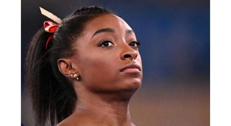 Biles's Olympic fate in balance as support pours in
