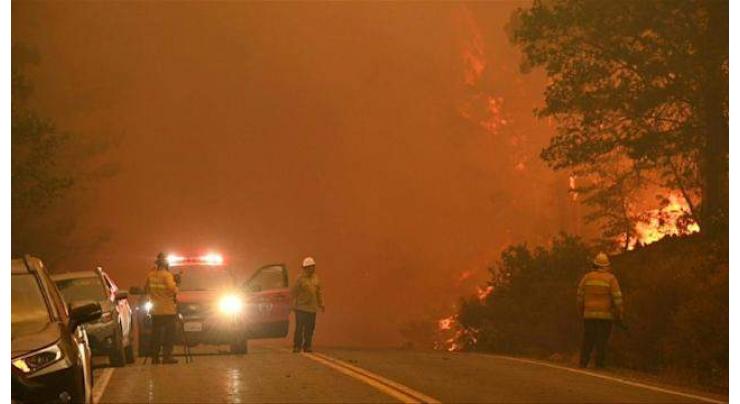 Wildfire levels historic California town as residents flee blaze
