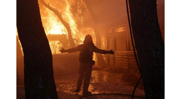 Greece still battling raging wildfires as weather worsens with strong winds
