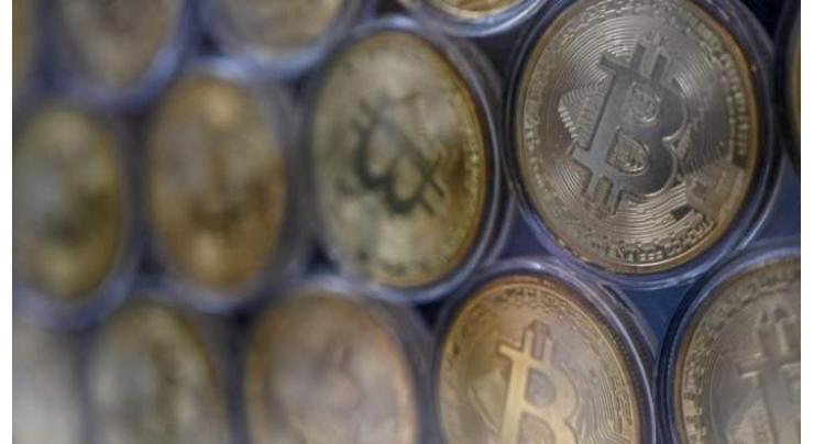 Bitcoin hits new record above $65,000 after Wall Street foray
