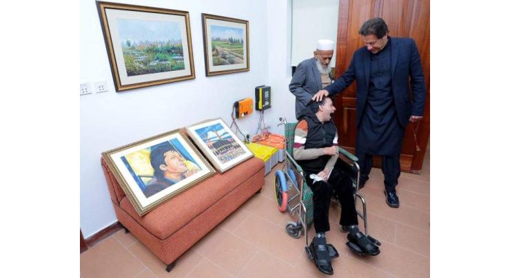 Artist suffering from cerebral palsy presents portraits to PM Imran Khan
