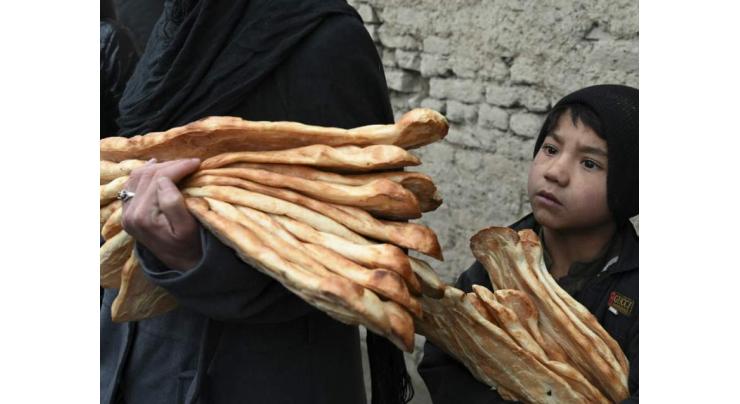 Desperate Afghans queue for free bread as poverty crisis deepens
