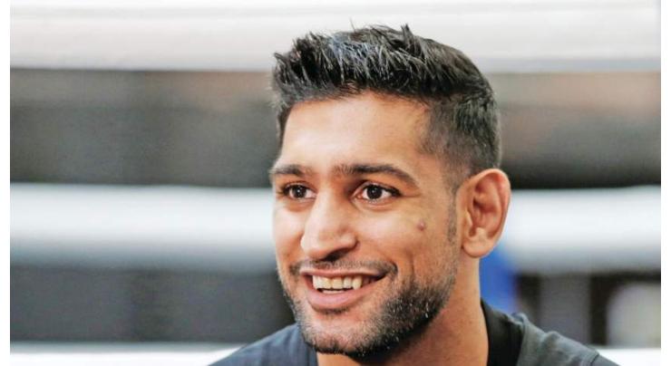 Ex-world champion Amir Khan retires from boxing
