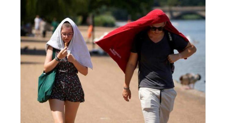 Britons desperate to cool off as mercury hits historic 40C
