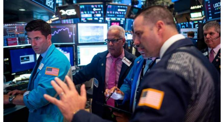 U.S. stock markets hover near record highs on positive earings