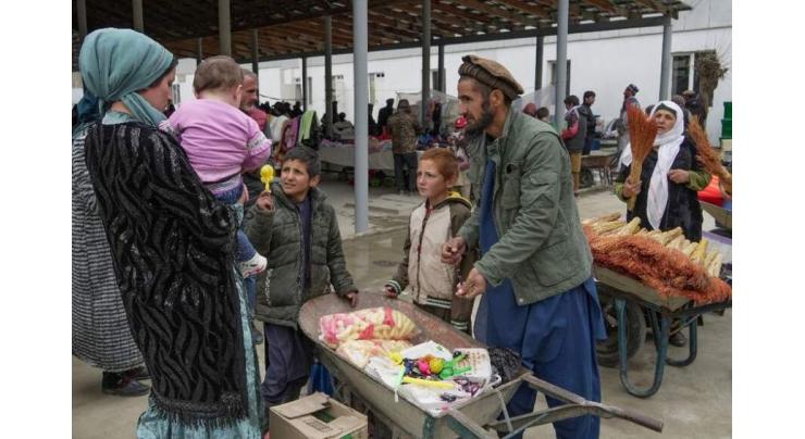 Afghans and Tajiks mix in rare but vital border bazaar