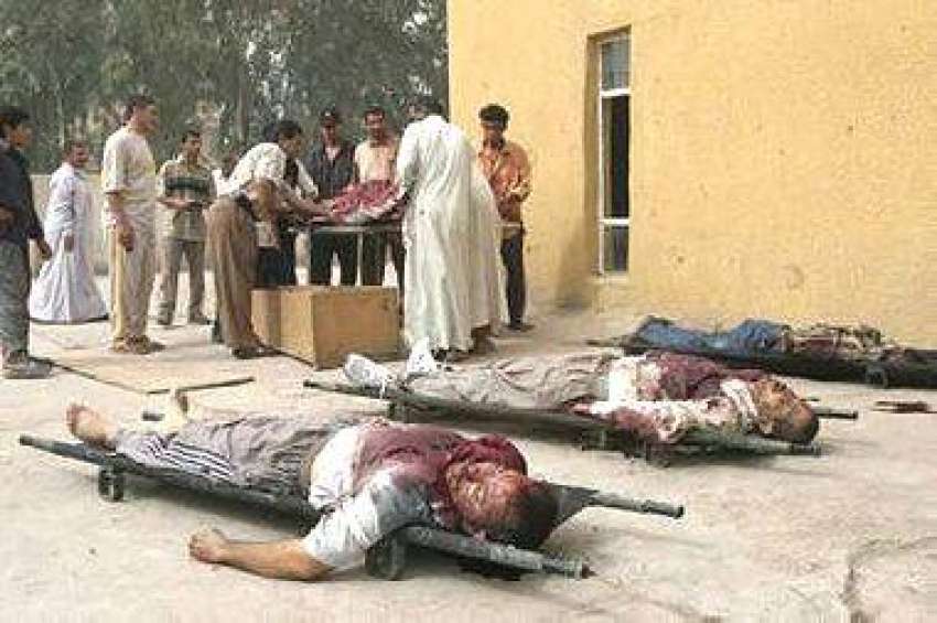 بغداد، نامعلوم افراد کی فائرنگ سے ہلاک ہونے والوں کی لاشوں ..