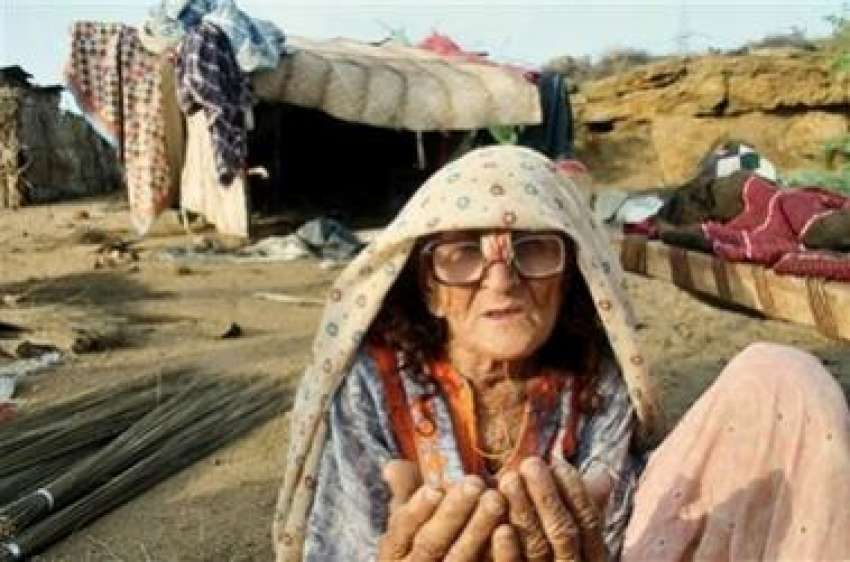 سلم ، ایک بوڑھی خاتون سیلاب سے اپنے تباہ شدہ گھر کے سامنے ..