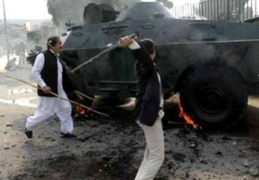 پشاور، مشتعل مظاہرین احتجاجی مظاہرے کے دوران پولیس کی بکتر ..