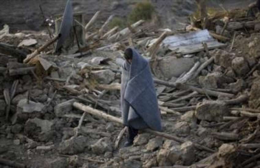 زیارت،زلزلے کے بعد ایک متاثرہ شخص تباہ شدہ علاقے میں سے ..
