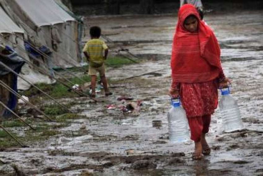نوشہرہ،سیلاب سے متاثرہ ٹینٹ‌کیمپ میں ایک بچی اپنے خاندان ..
