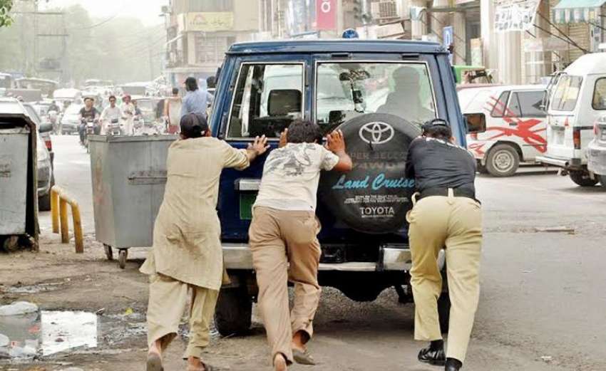 لاہور، مال روڈ‌پر پولیس اہلکار اور شہری خراب گاڑی کو دھکا ..