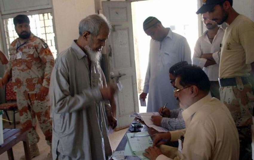 کراچی: حلقہ NA246کے ضمنی الیکشن کے موقع پر ایک بزرگ بیلٹ پیپرز ..