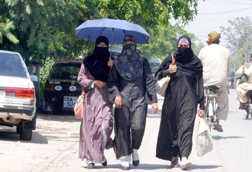 راولپنڈی: شدید گرمی کے باعث خواتین دھوپ سے بچنے کے لیے چھتری ..
