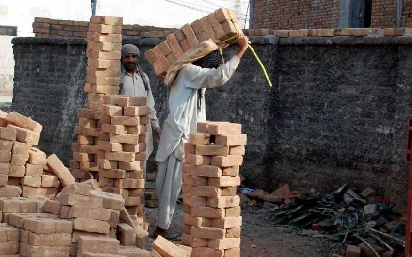 راولپنڈی: نواحی علاقے میں زیر تعمیر عمارت کے لیے مزدور اینٹیں ..