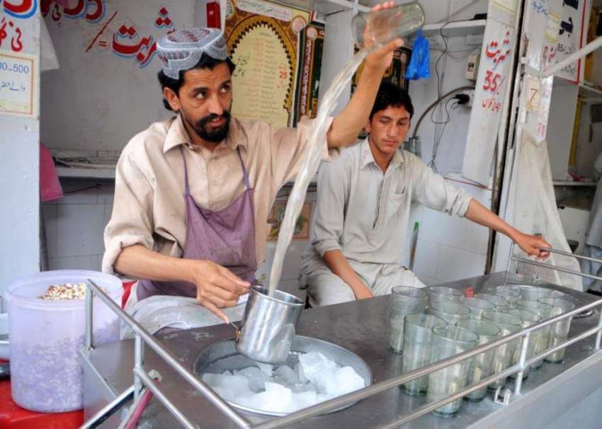 لاہور: ایک دوکاندار گرمی شدت میں اضافے کے پیاس کم کرنے کے ..