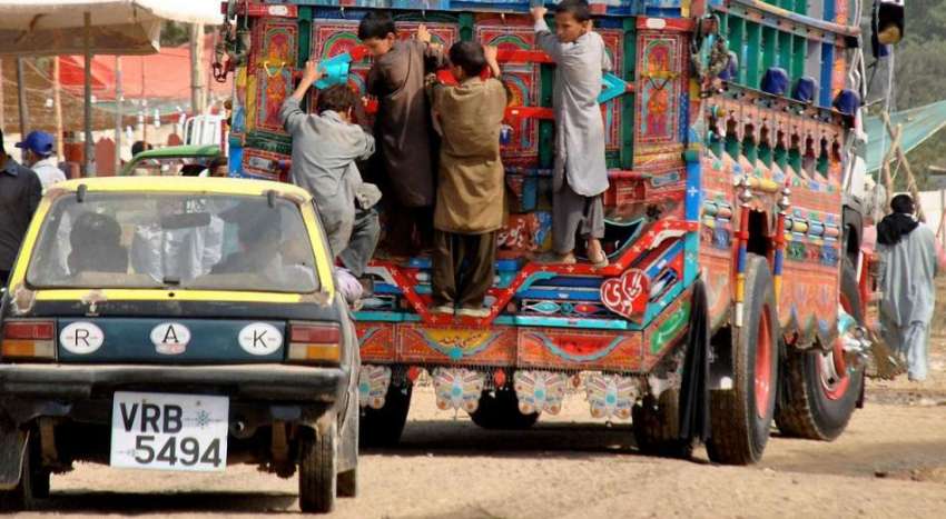 راولپنڈی: پیر ودھائی روڈ پر خانہ بدوش بچے ایک ٹرک پر لٹک ..