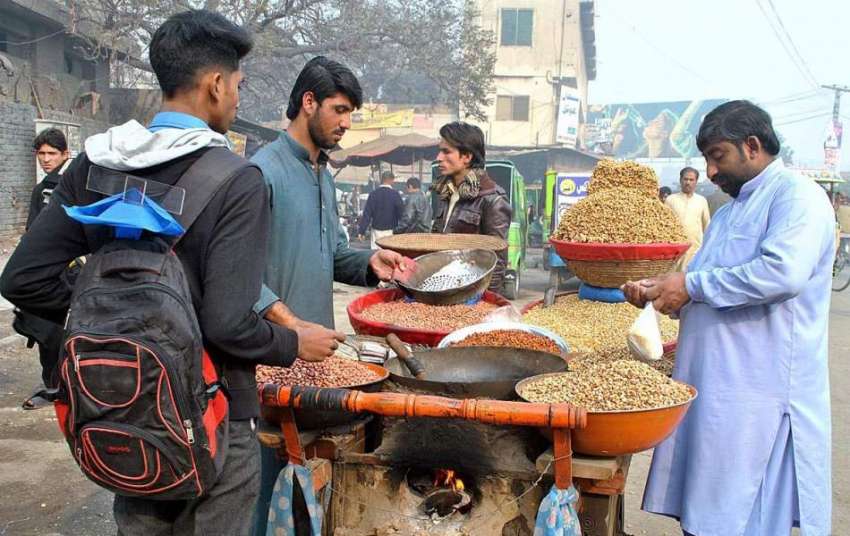 لاہور: ریڑھی بان بھنے ہوئے چنے فروخت کر رہا ہے۔