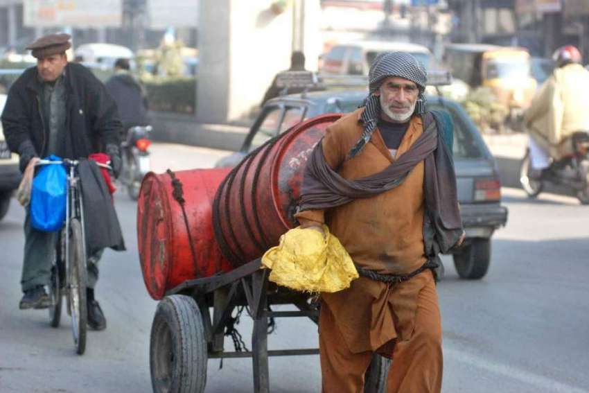 راولپنڈی: ایک معمر محنت کش ہتھ ریڑھی پر بھاری ڈرم رکھے جا ..