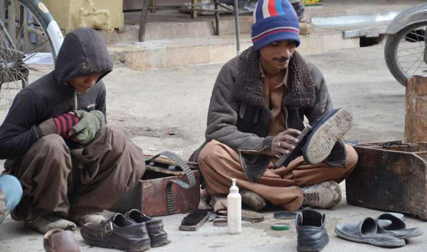 کوئٹہ: جناح روڈ پر دو محنت کش جوتے پالش کرنے میں مصروف ہیں۔