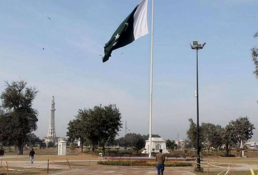 لاہور: گریٹر اقبال پارک میں لگے قومی پرچم اور عقب میں نظر ..