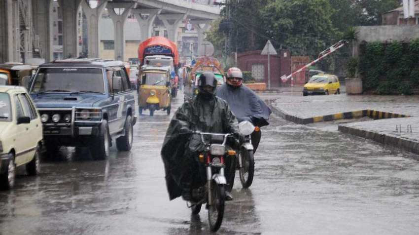 راولپنڈی: بارش سے بچنے کے لیے موٹر سائیکل سوار برساتی پہنے ..