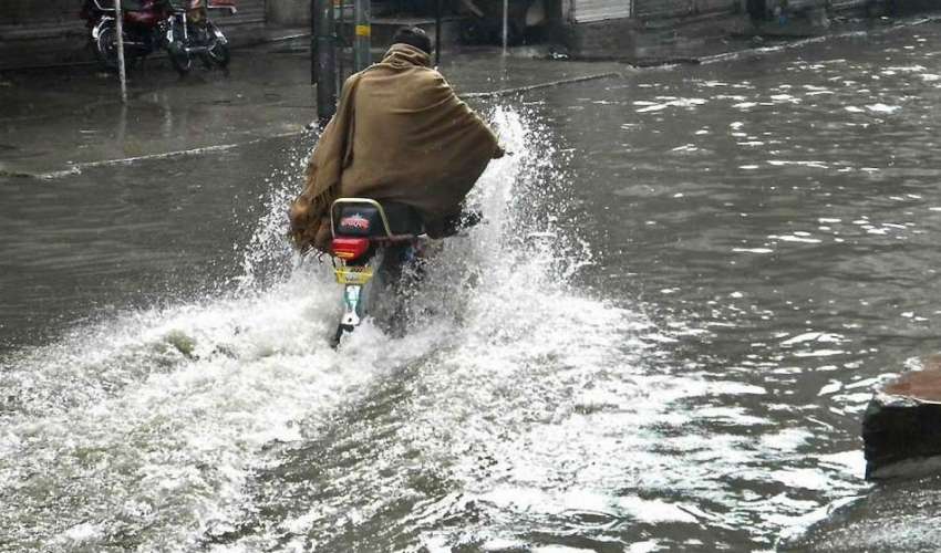 راولپنڈی: موٹر سائیکل سوار بارش کے پانی سے گزر رہا ہے۔