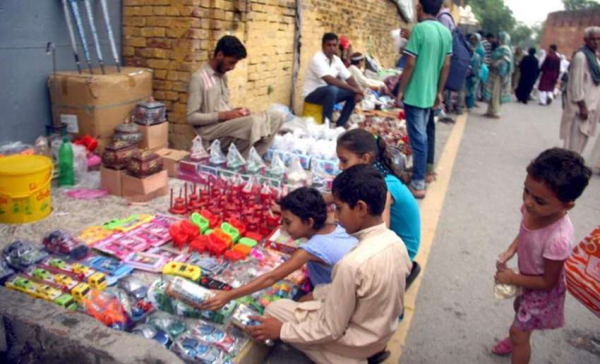 لاہور: شاہی قلعہ کے داخلی دروازے پر لگی دکان سے بچے کھلونے ..
