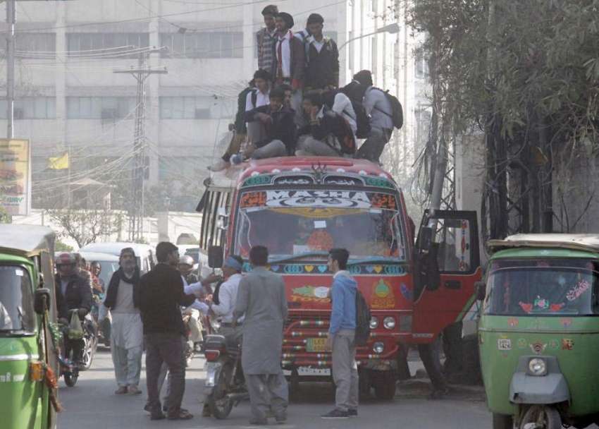 لاہور: طالبعلم بس کی چھت پر سوار ہیں جو کسی بھی حادثے کا شکار ..