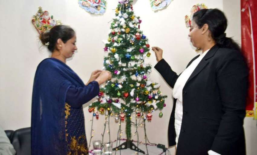 لاہور: مسیحی خواتین گھر میں کرسمس ٹری سجا رہی ہیں۔