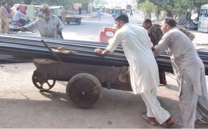 لاہور: محنت کش ہتھ ریڑھیوں پرلوہے کا بھاری سامان رکھے جا ..