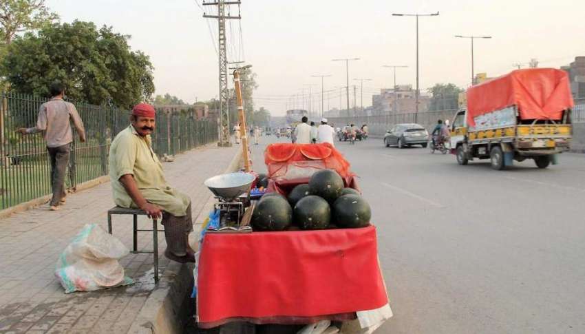 لاہور: راوی روڈ پر ایک شخص تربوز فروخت کرنے کے لیے گاہکوں ..