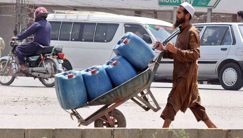 راولپنڈی: مزدور ہتھ ریڑھی پر پلاسٹک کے کین رکھے پانی بھرنے ..