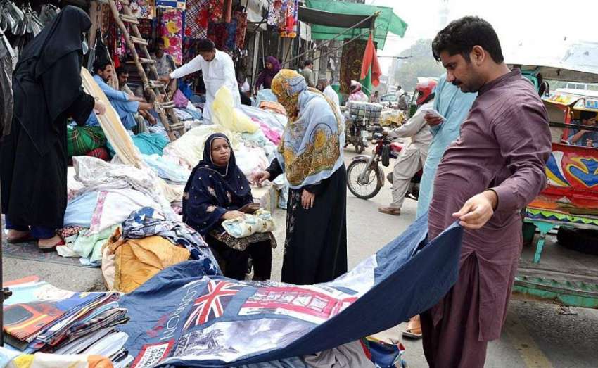 لاہور: دکاندار فروخت کے لیے پرانے کمبل سجار ہا ہے۔