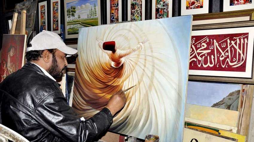 اسلام آباد: لوک میلہ 2018میں شریک ایک آرٹسٹ پینٹنگ بنا رہا ..
