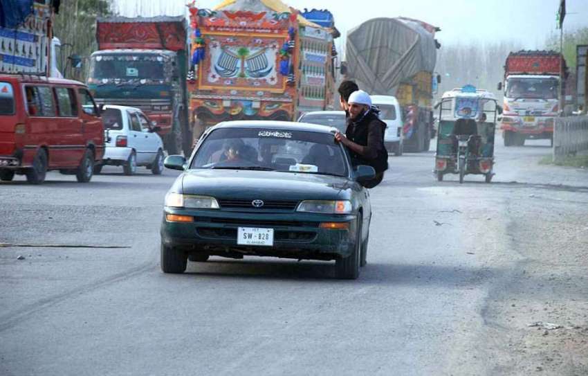 پشاور: شہری کار کے دروازے میں بیٹھ کر خطرناک انداز سے سفر ..