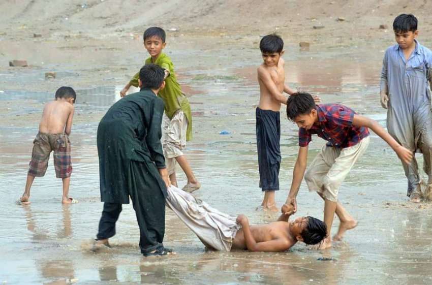 ملتان: بچے بارش کے دوران کھیل کود میں مصروف ہے۔