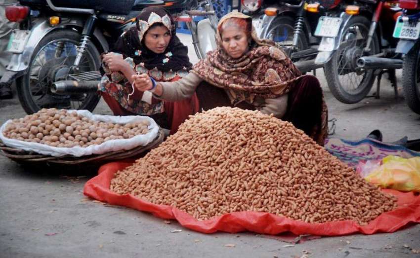لاہور:خواتین مال روڈ پر مونگ پھلی اور اخروٹ بیچ رہی ہیں۔