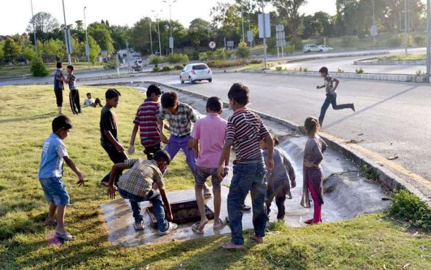 اسلام آباد: بچے گرین بیلٹ پر لگے پانی کے والو کو کھلولنے ..