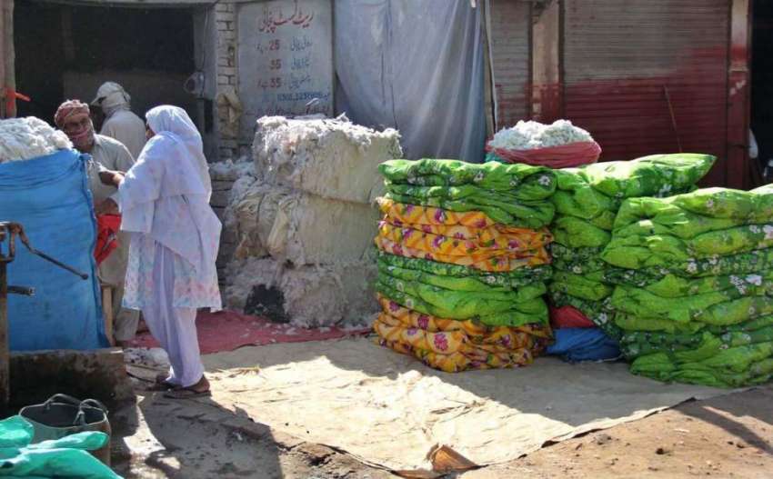 سرگودھا: ایک خاتون سڑک کنارے لگے سٹال سے روئی خرید رہی ہے۔