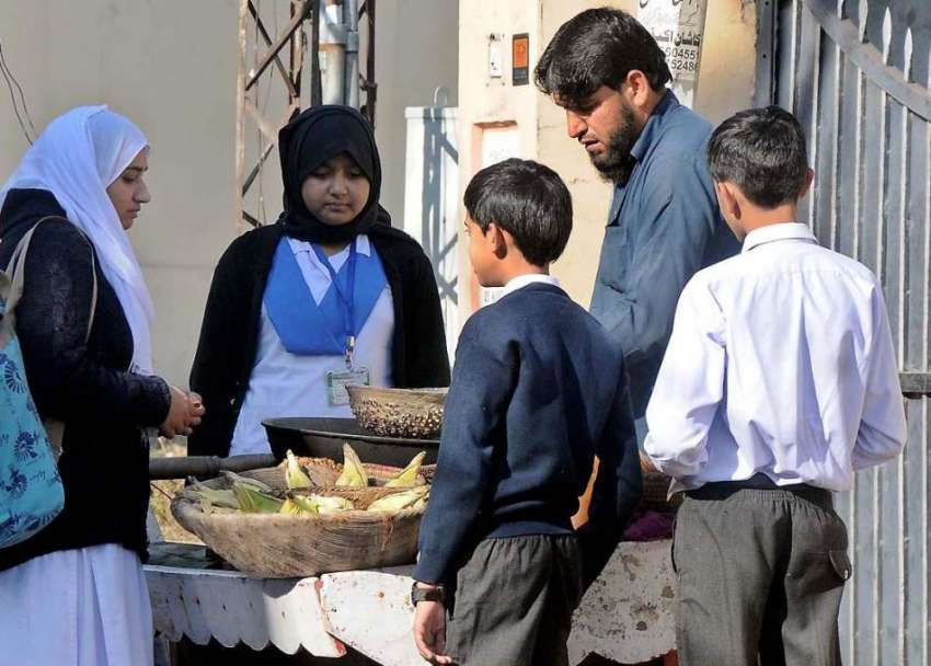 راولپنڈی: سکول کے باہر بچے مکئی کے دانے خرید رہے ہیں۔