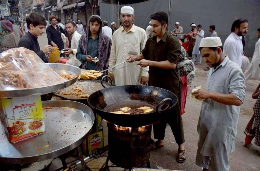 پشاور: دکاندار گاہکوں کو متوجہ کرنے کے لیے سموسے بنا رہے ..