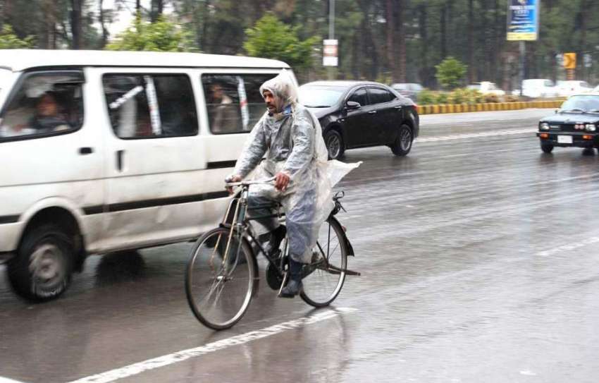 اسلام آباد: سائیکل سوار بارش سے بچنے کے لیے پلاسٹک شیٹ اوڑھے ..