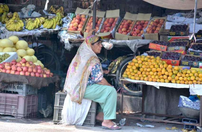 فیصل آباد: خاتون دکاندار فروٹ سجائے گاہکوں کی منتظر ہے۔