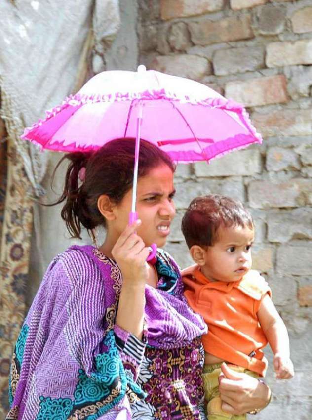 اسلام آباد: ایک خاتون دھوپ سے بچنے کے چھتری تان جا رہی ہے۔