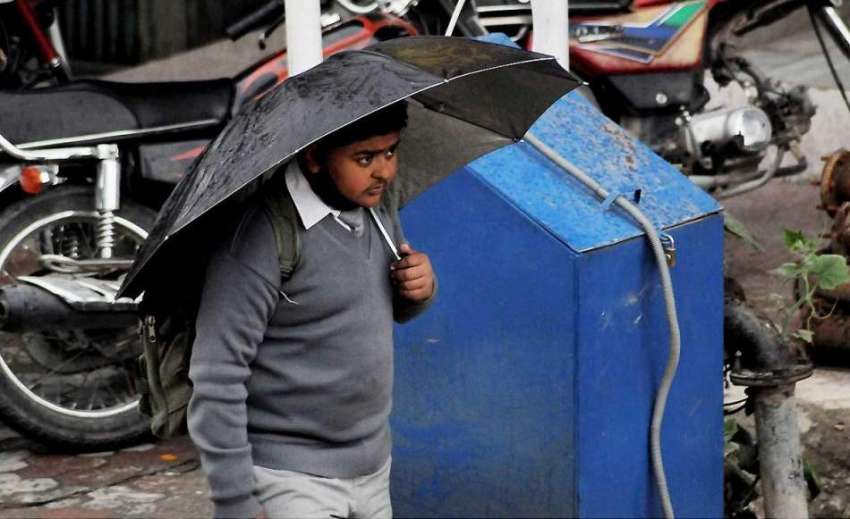 اسلام آباد: طالبعلم چھٹی کے بعد بارش سے بچنے کے لیے چھتری ..