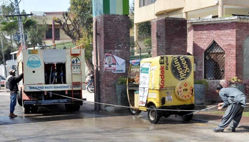 راولپنڈی: ویسٹ مینجمنٹ کے اہلکار رکشہ کی صفائی ستھرائی کر ..