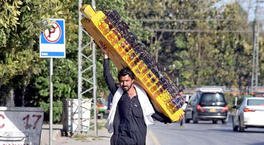 راولپنڈی: محنت کش دھوپ سے بچاؤ والی عینکیں فروخت کے لیے اٹھائے ..