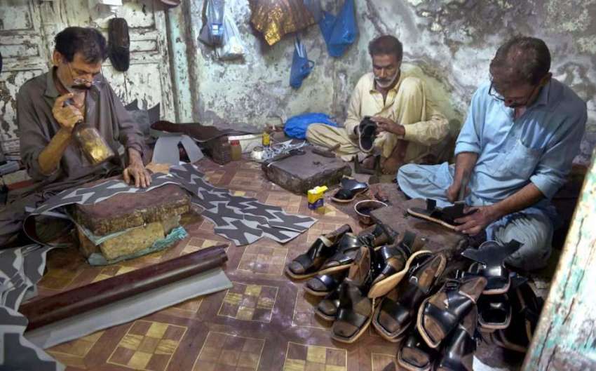 راولپنڈی: عیدالفطر کی آمد کے پیش نظر محنت کش جوتے بنانے میں ..